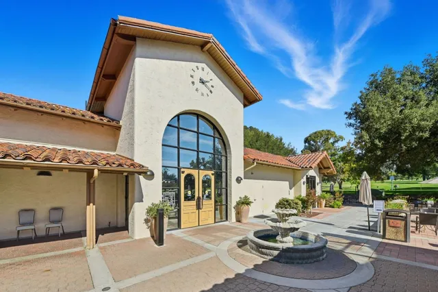 a sign board with buildings in the background