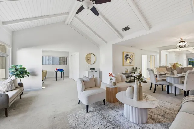 a living room with furniture and a potted plant