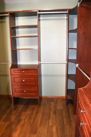 a view of walk in closet with empty racks