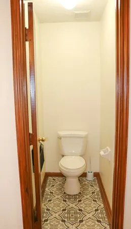 a bathroom with a toilet and a shower curtain