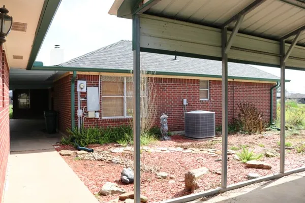 a view of a brick house with a glass door