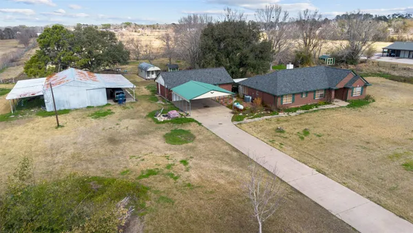 a view of a house with a yard and sitting area
