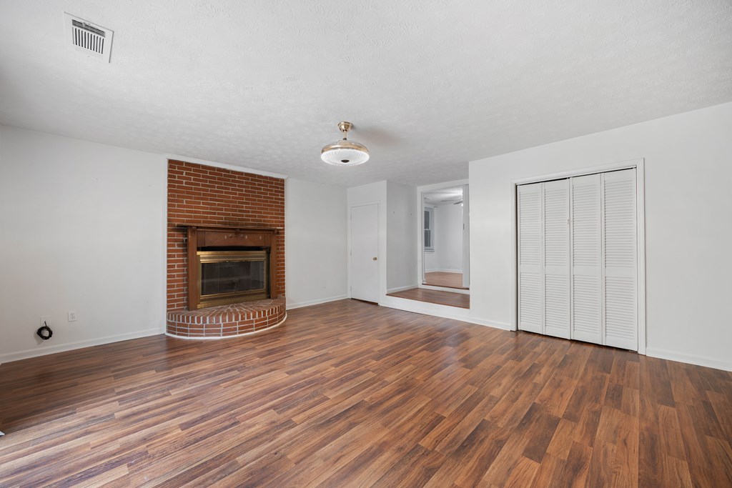 111 East Bon Acre Road Cataula, GA 31804 - Photo 12 of 16 a view of empty room with wooden floor and kitchen