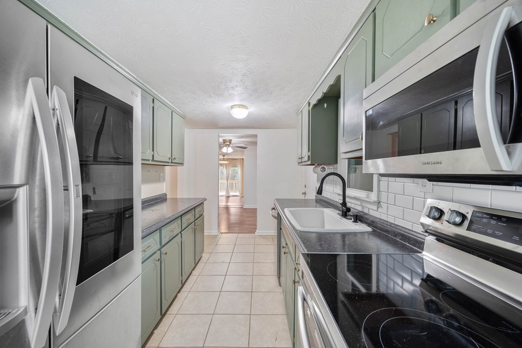 111 East Bon Acre Road Cataula, GA 31804 - Photo 3 of 16 a kitchen with stainless steel appliances granite countertop a refrigerator and a stove