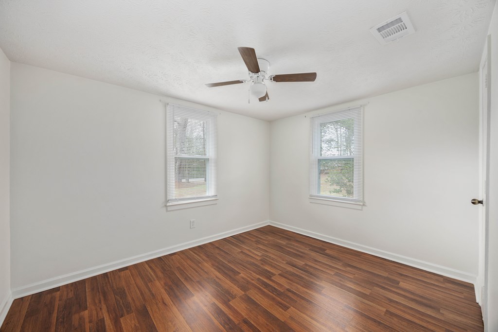 111 East Bon Acre Road Cataula, GA 31804 - Photo 9 of 16 a view of an empty room with a window and wooden floor