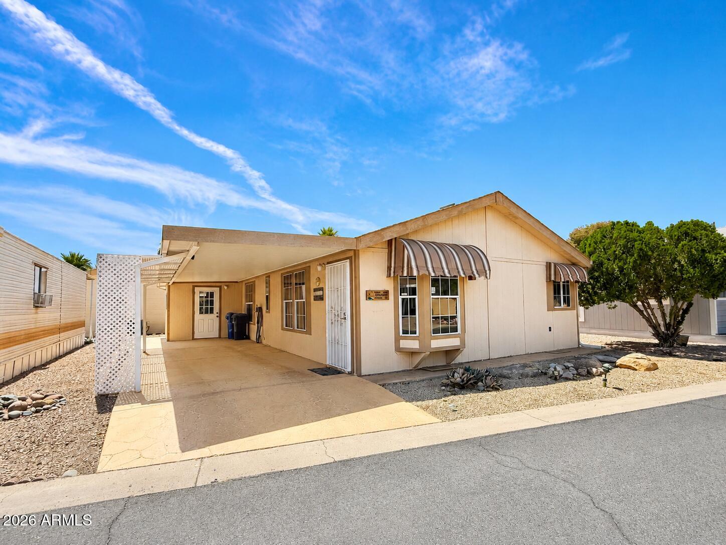 8865 East Baseline Road, Unit 103 Mesa, AZ 85209 - Photo 29 of 47 a front view of a house with a yard