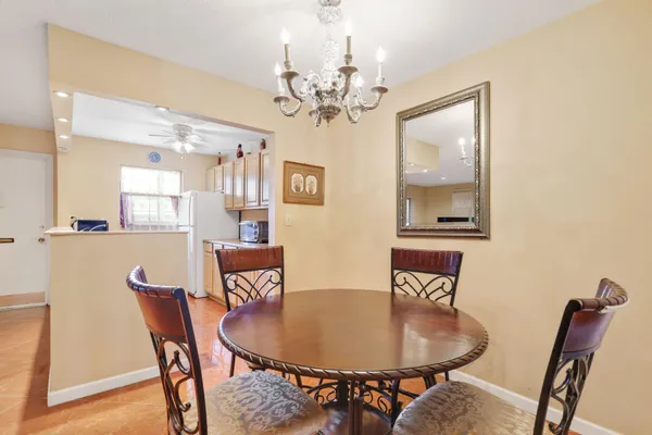 a dining room with furniture and chandelier