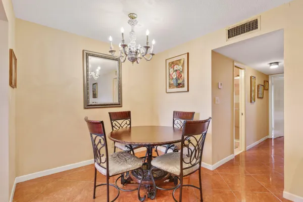 a view of a dining room with furniture and chandelier