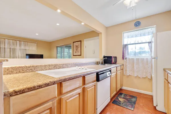 a kitchen with stainless steel appliances granite countertop a sink and a stove