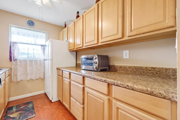 a kitchen with granite countertop cabinets and window