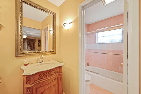a bathroom with a sink a vanity and a mirror