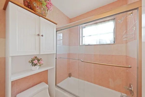 a bathroom with a shower and a sink