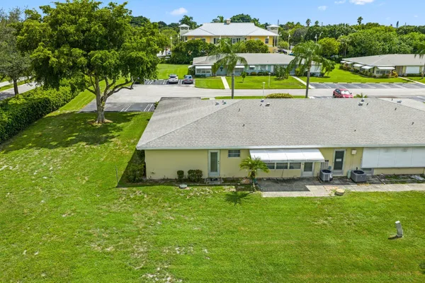 an aerial view of a house with a garden and swimming pool