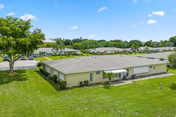 an aerial view of a house with swimming pool and a yard