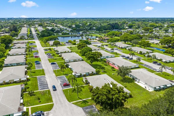 an aerial view of multiple houses with yard