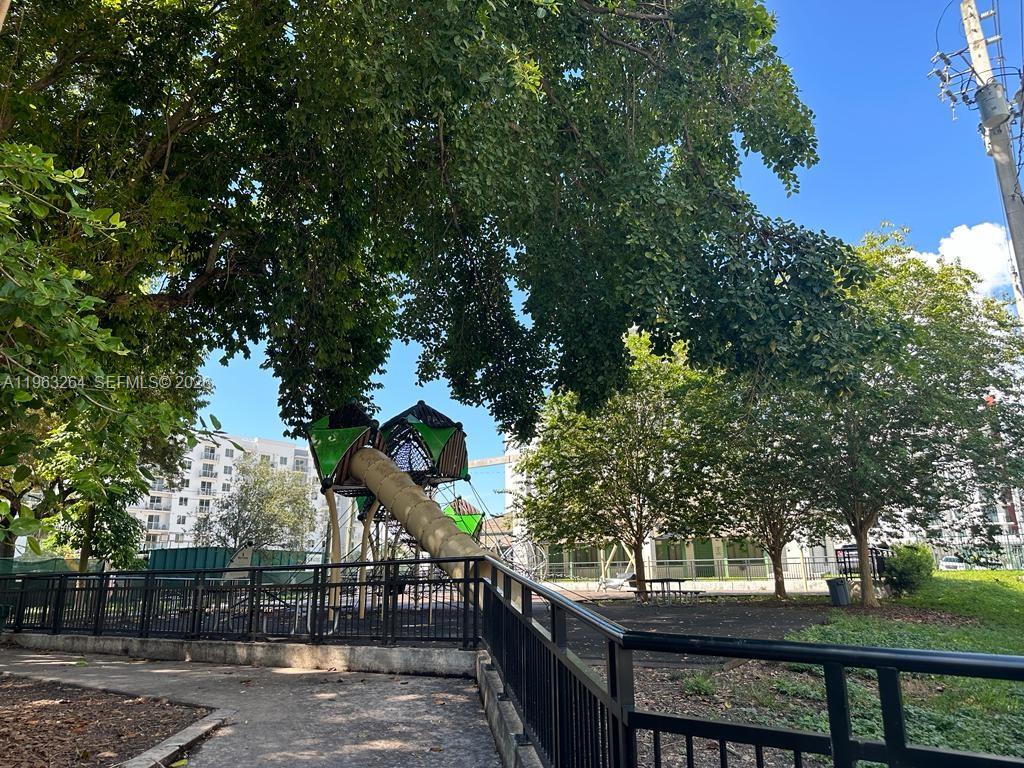 115 Southwest 11th Street, Unit 805 Miami, FL 33130 - Photo 12 of 13 a view of a wooden fence and trees