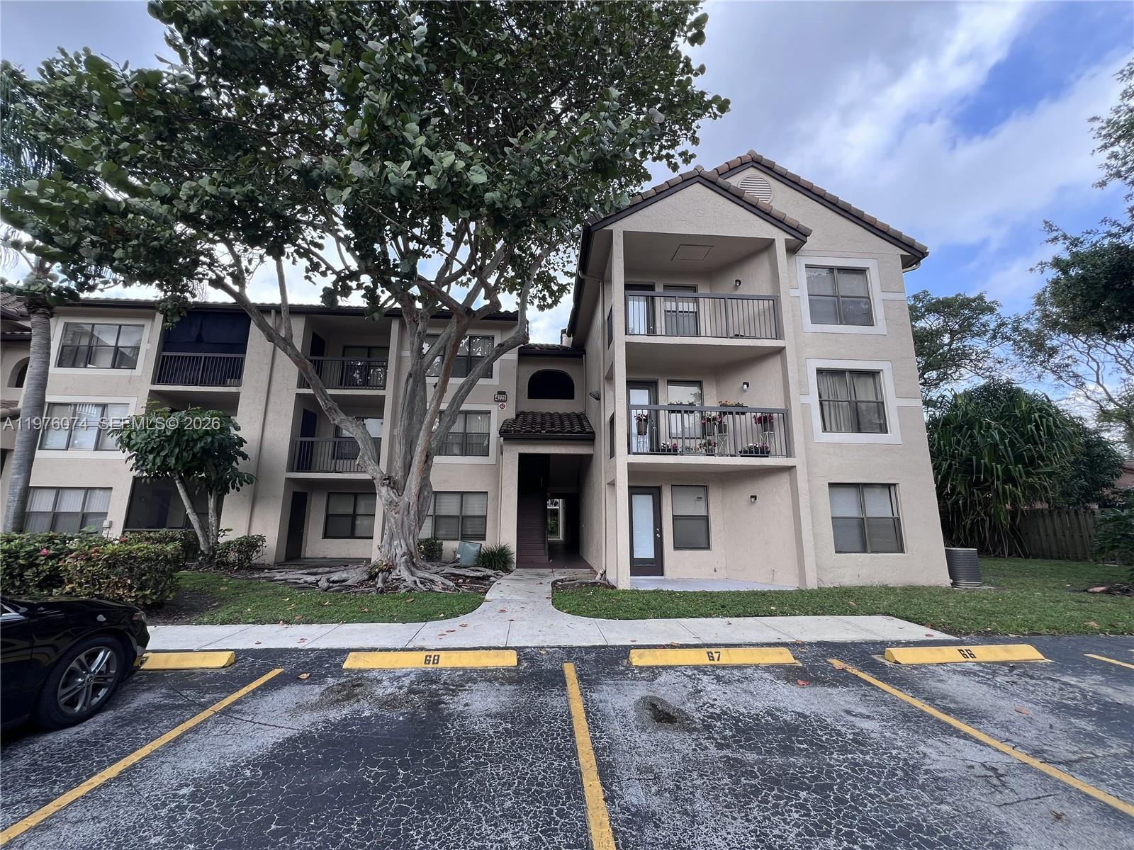 4221 West McNab Road, Unit 43 Pompano Beach, FL 33069 - Photo 11 of 17 a front view of a house with a yard