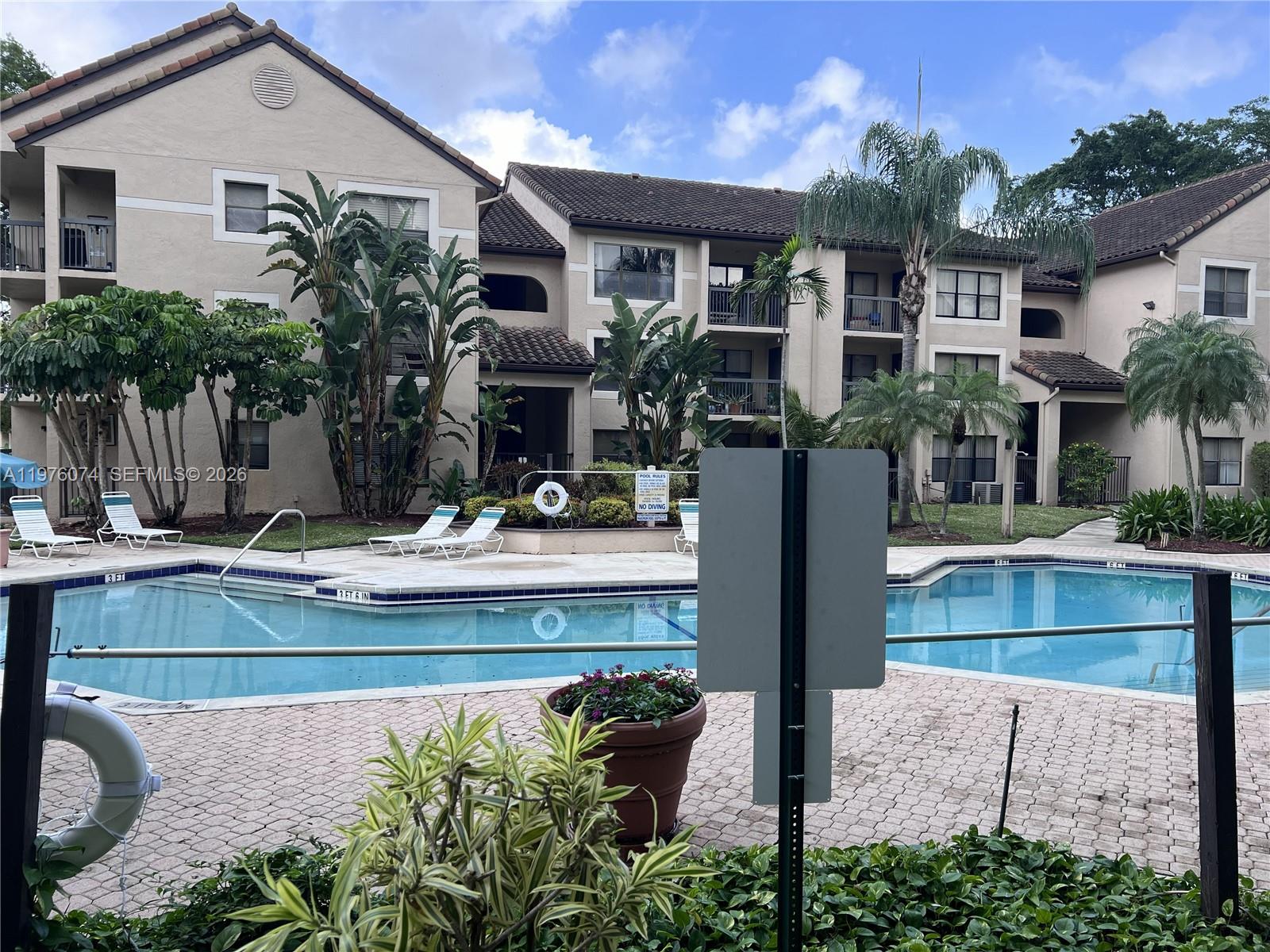 4221 West McNab Road, Unit 43 Pompano Beach, FL 33069 - Photo 12 of 17 a view of house with outdoor space and swimming pool
