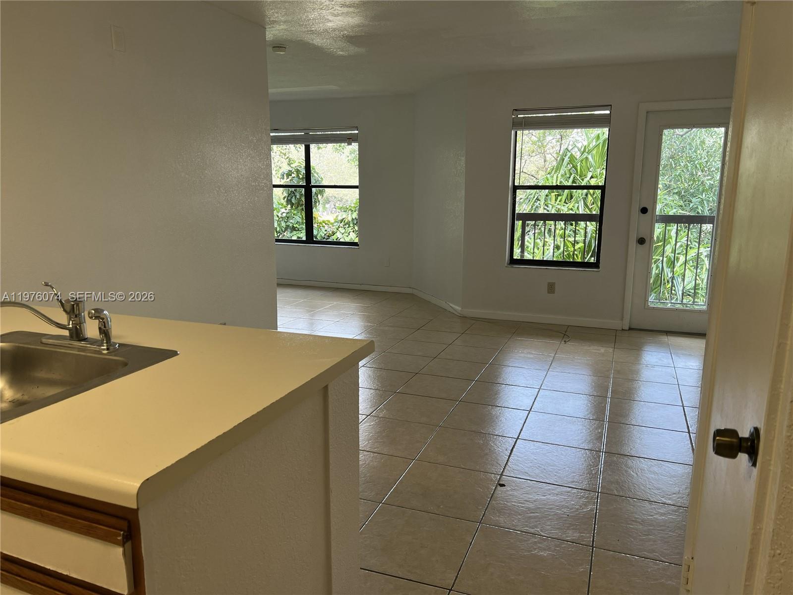 4221 West McNab Road, Unit 43 Pompano Beach, FL 33069 - Photo 12 of 23 a kitchen with a sink a window and a stove