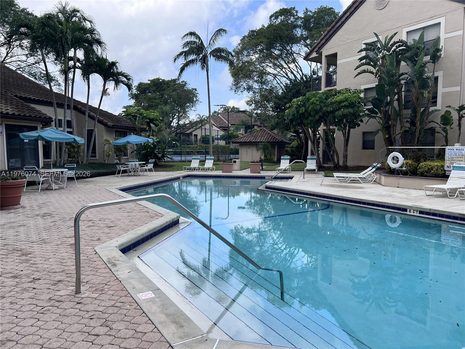 4221 West McNab Road, Unit 43 Pompano Beach, FL 33069 - Photo 13 of 17 a view of a patio with swimming pool table and chairs