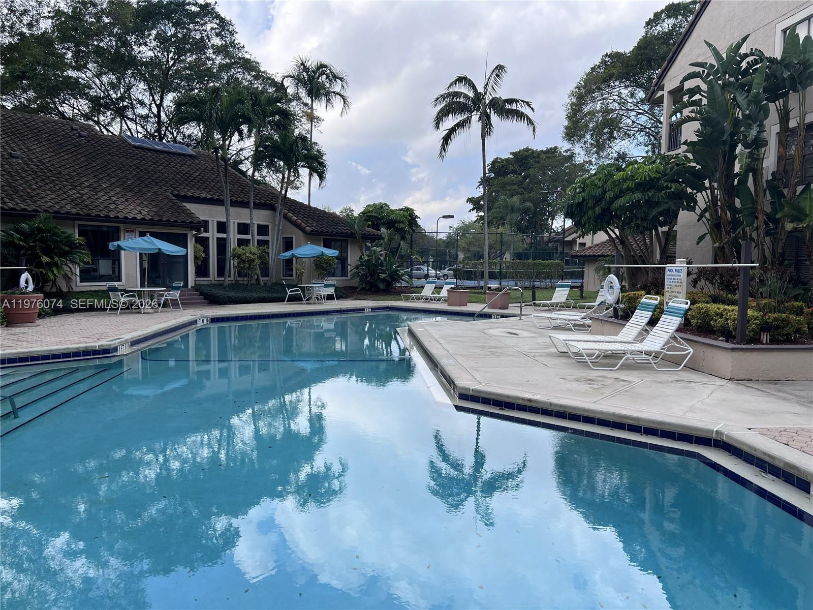4221 West McNab Road, Unit 43 Pompano Beach, FL 33069 - Photo 20 of 23 a view of a swimming pool with a patio