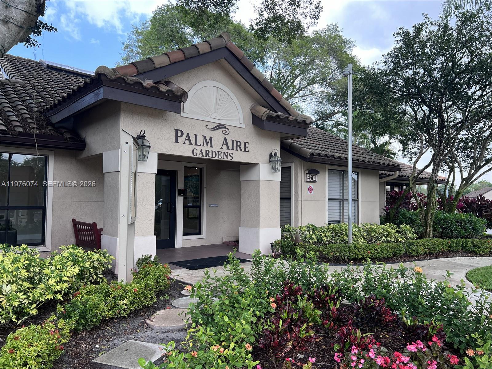 4221 West McNab Road, Unit 43 Pompano Beach, FL 33069 - Photo 2 of 23 a front view of a house with garden