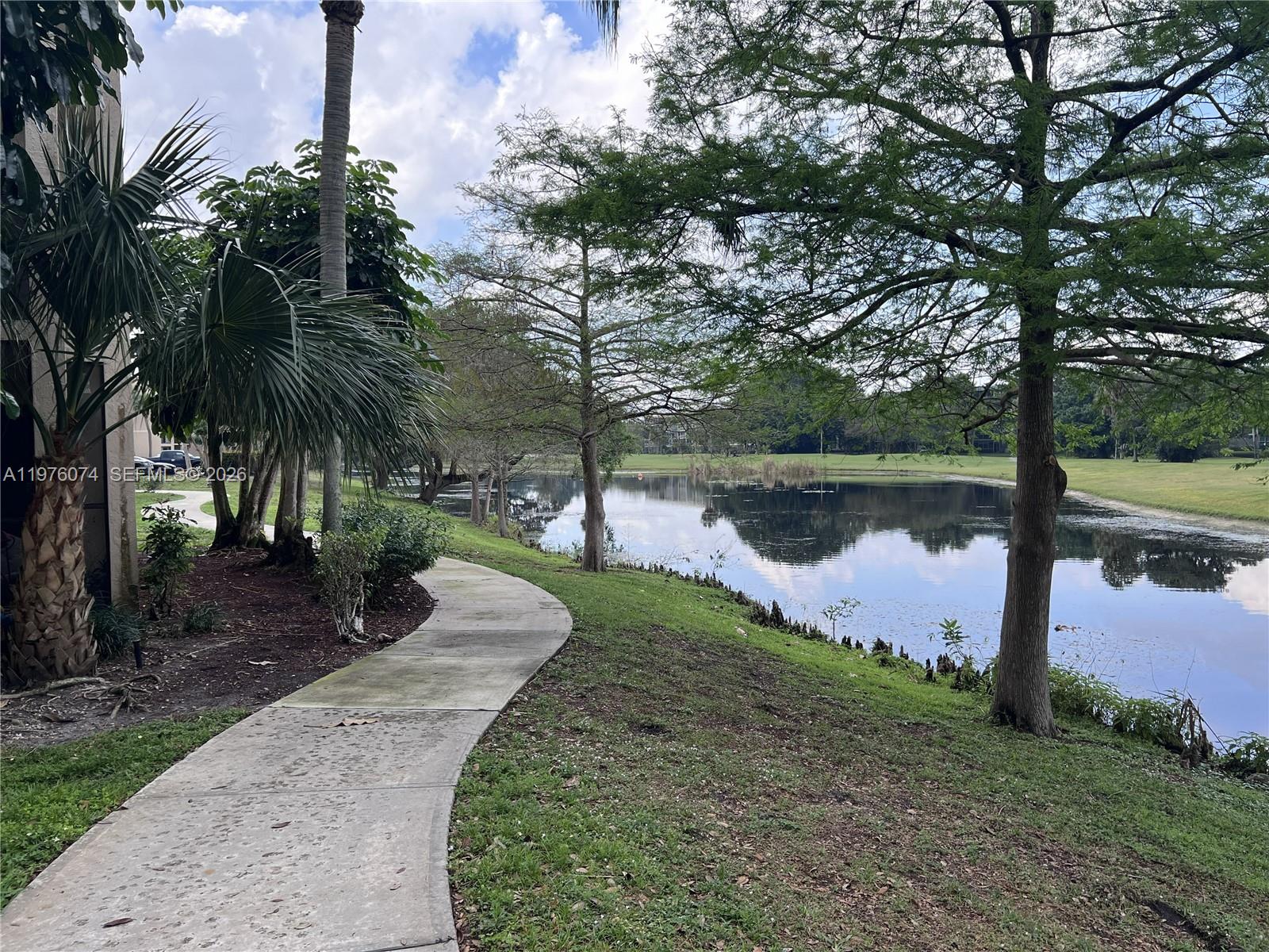 4221 West McNab Road, Unit 43 Pompano Beach, FL 33069 - Photo 23 of 23 a lake view with a garden