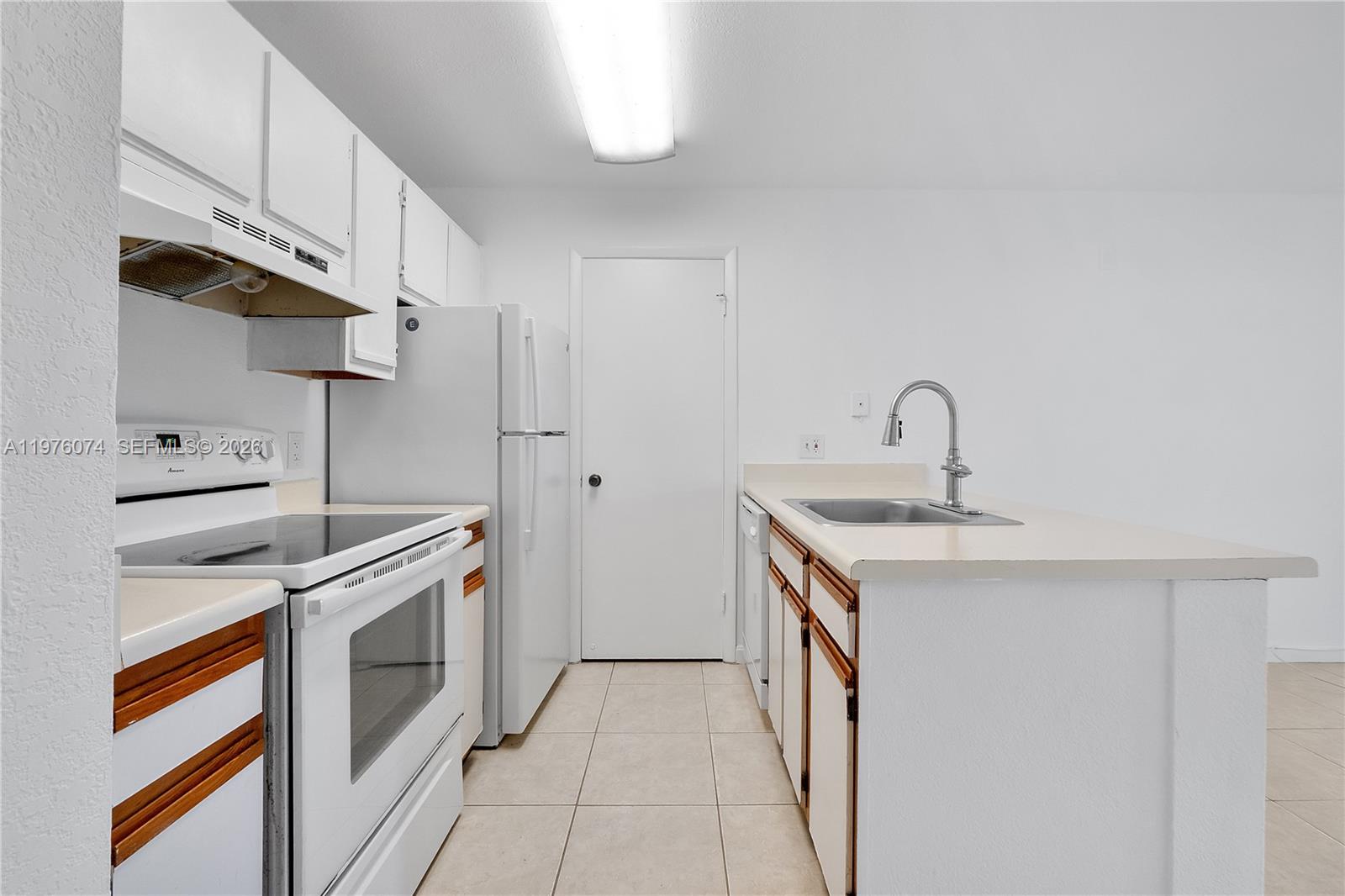 4221 West McNab Road, Unit 43 Pompano Beach, FL 33069 - Photo 3 of 17 a kitchen with stainless steel appliances granite countertop a sink and a stove