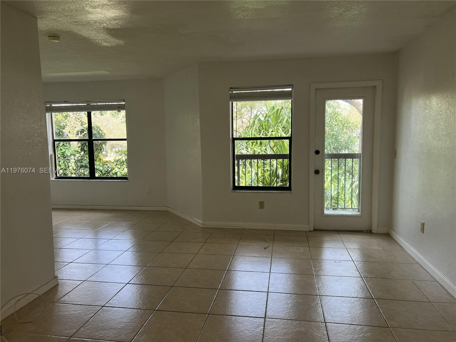 4221 West McNab Road, Unit 43 Pompano Beach, FL 33069 - Photo 3 of 23 a view of an empty room with a window