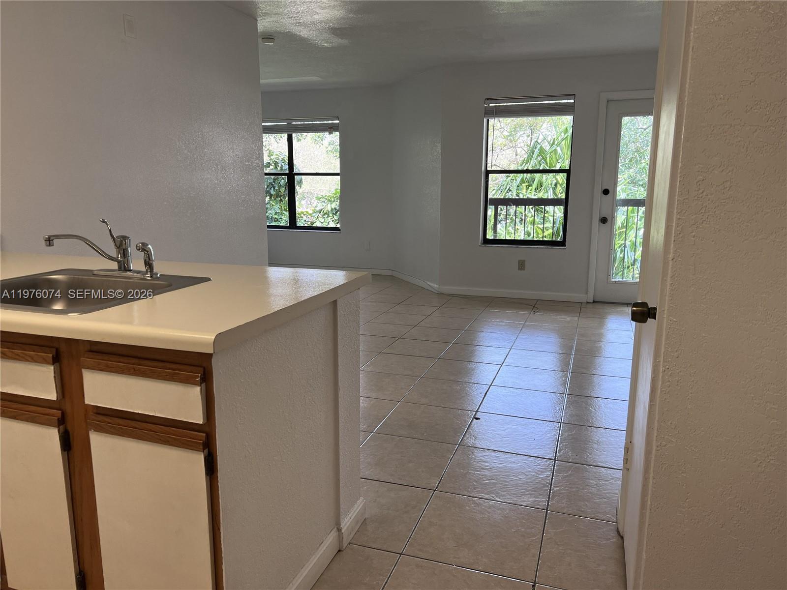 4221 West McNab Road, Unit 43 Pompano Beach, FL 33069 - Photo 4 of 23 a kitchen with a sink cabinets and a window