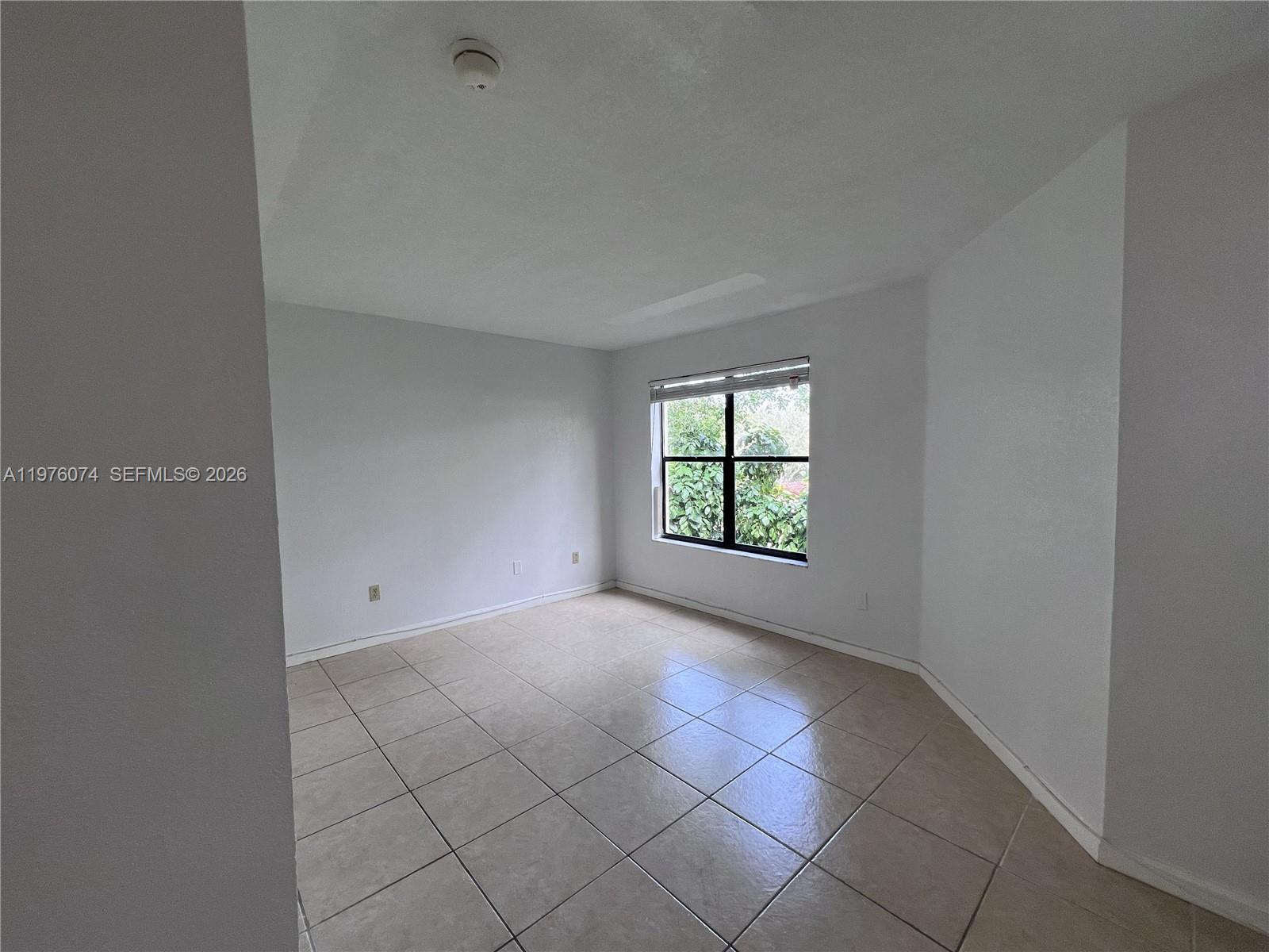 4221 West McNab Road, Unit 43 Pompano Beach, FL 33069 - Photo 6 of 23 an empty room with windows
