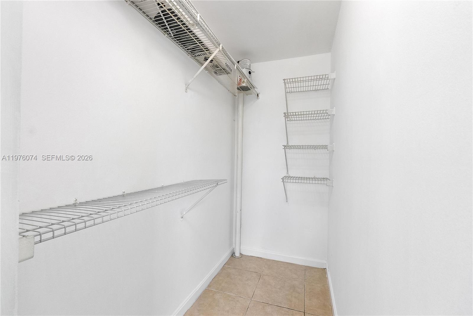 4221 West McNab Road, Unit 43 Pompano Beach, FL 33069 - Photo 7 of 17 a view of walk in closet with empty racks