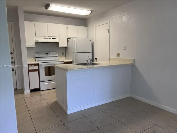 a kitchen with a sink cabinets and stainless steel appliances