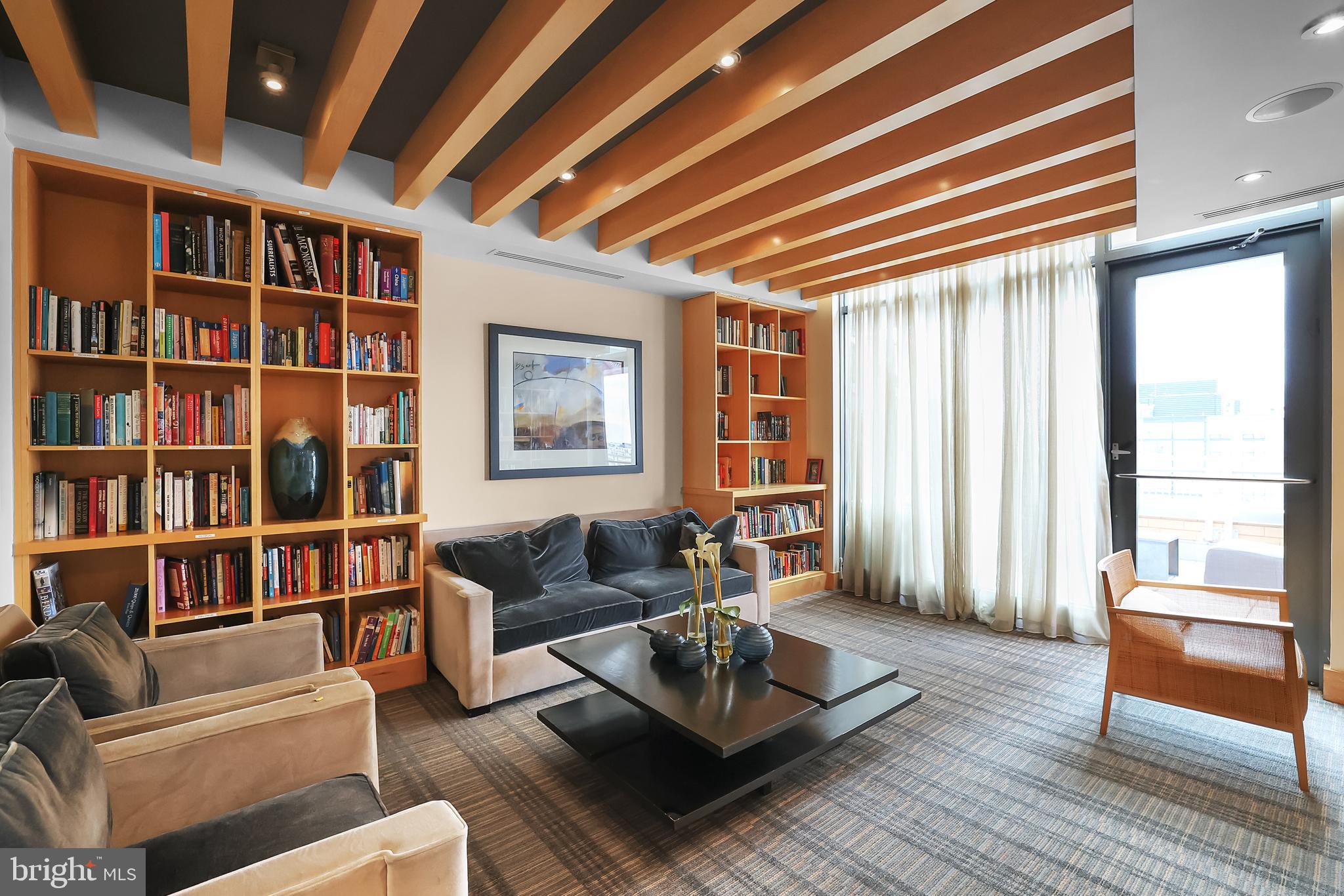 475 K Street Northwest, Unit 920 Washington, DC 20001 - Photo 18 of 25 a living room with furniture and a book shelf