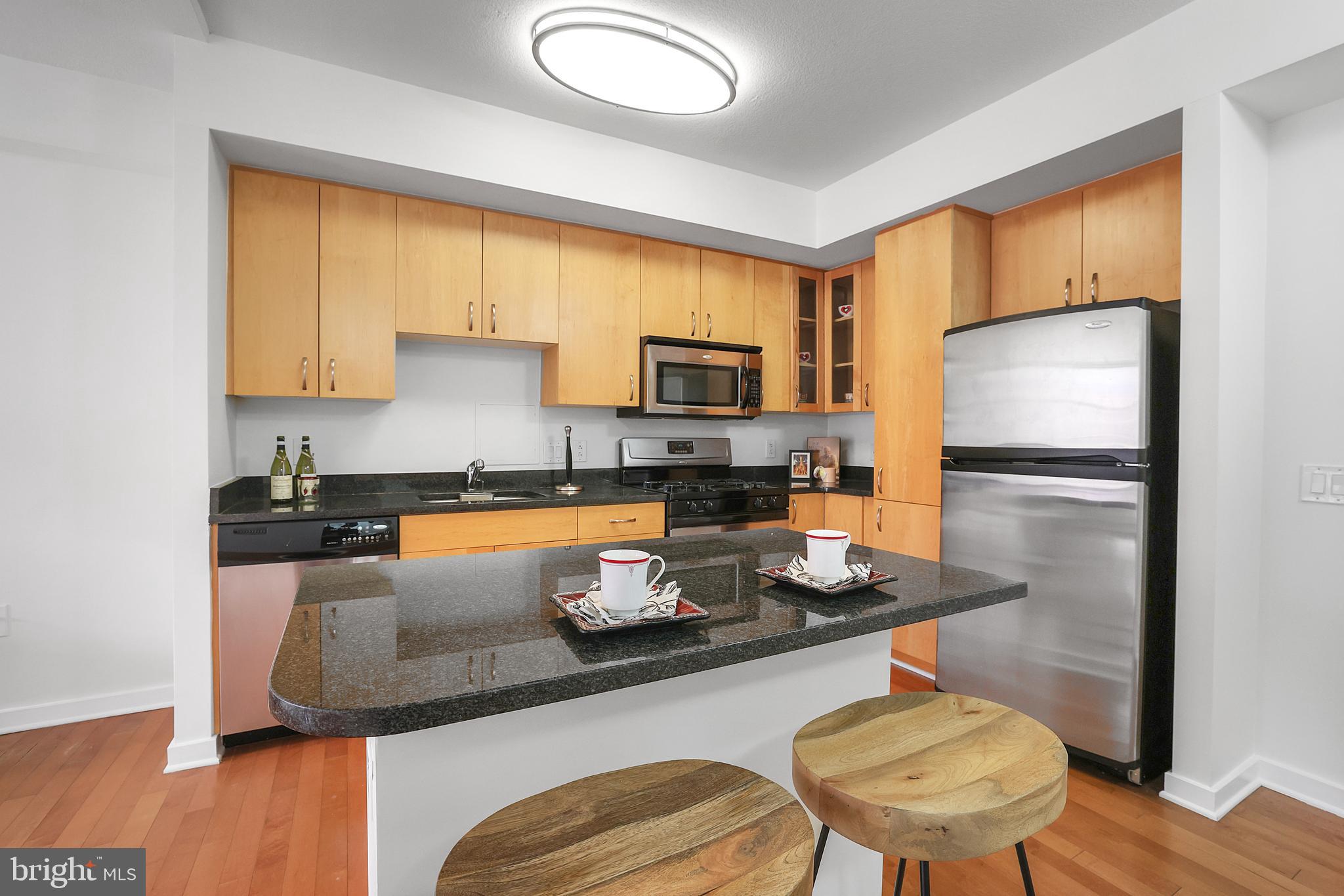 475 K Street Northwest, Unit 920 Washington, DC 20001 - Photo 5 of 25 a kitchen with a refrigerator and a stove top oven