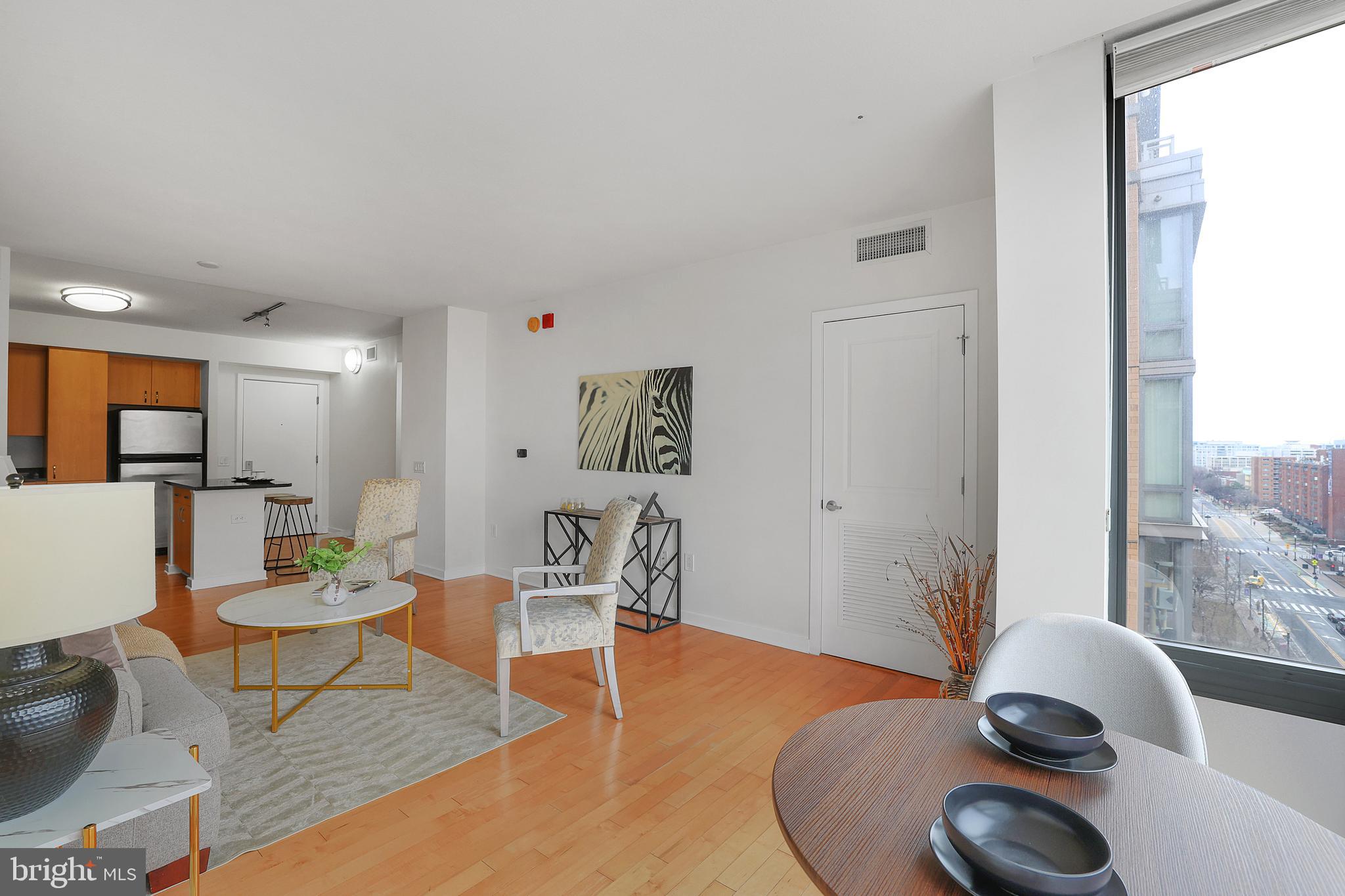 475 K Street Northwest, Unit 920 Washington, DC 20001 - Photo 9 of 25 a living room with furniture a rug and a large window