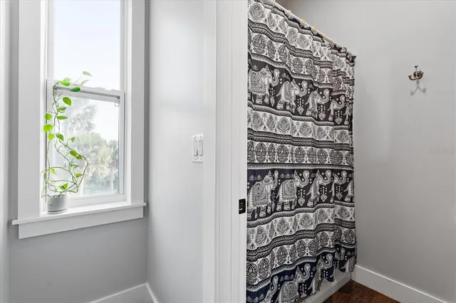 a bedroom with a bed and a dresser next to a window