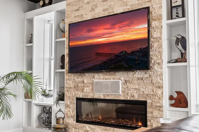 a kitchen with stainless steel appliances granite countertop a refrigerator a stove and a wooden floors