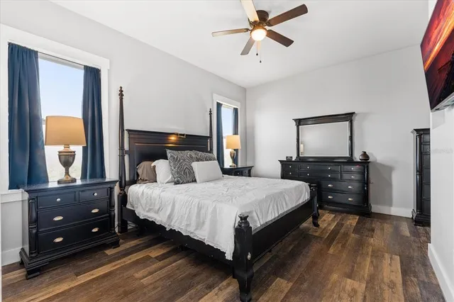 a living room with furniture kitchen view and a large window