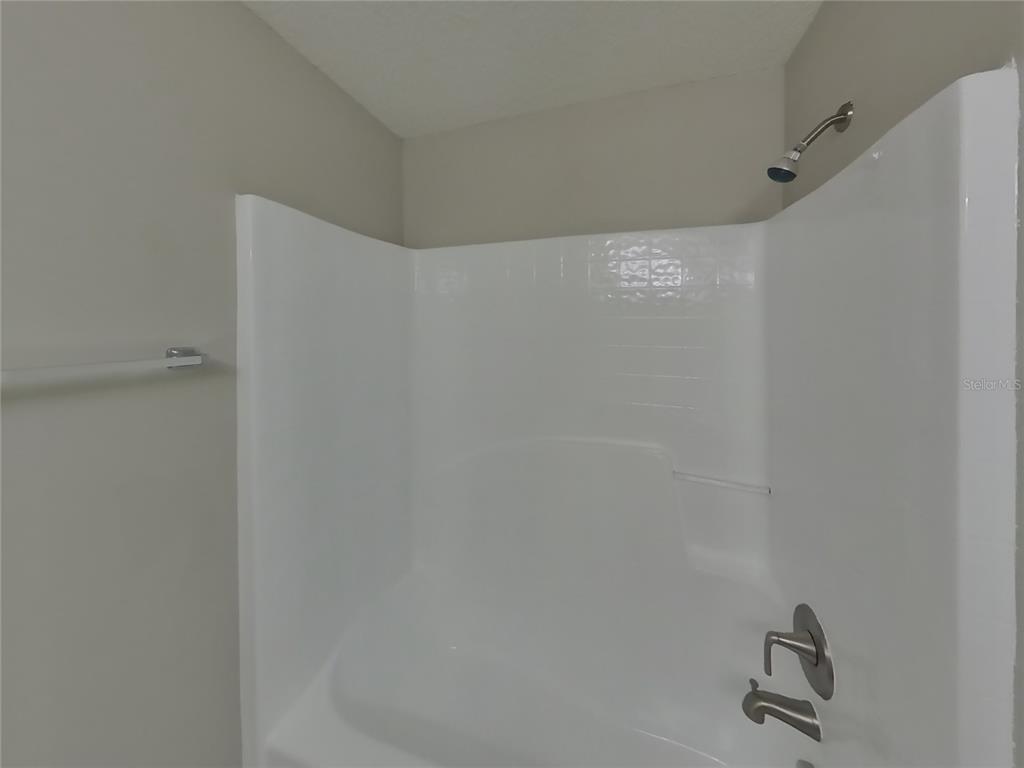 Undisclosed Address Spring Hill, FL 34609 - Photo 14 of 17 a bathroom with a shower