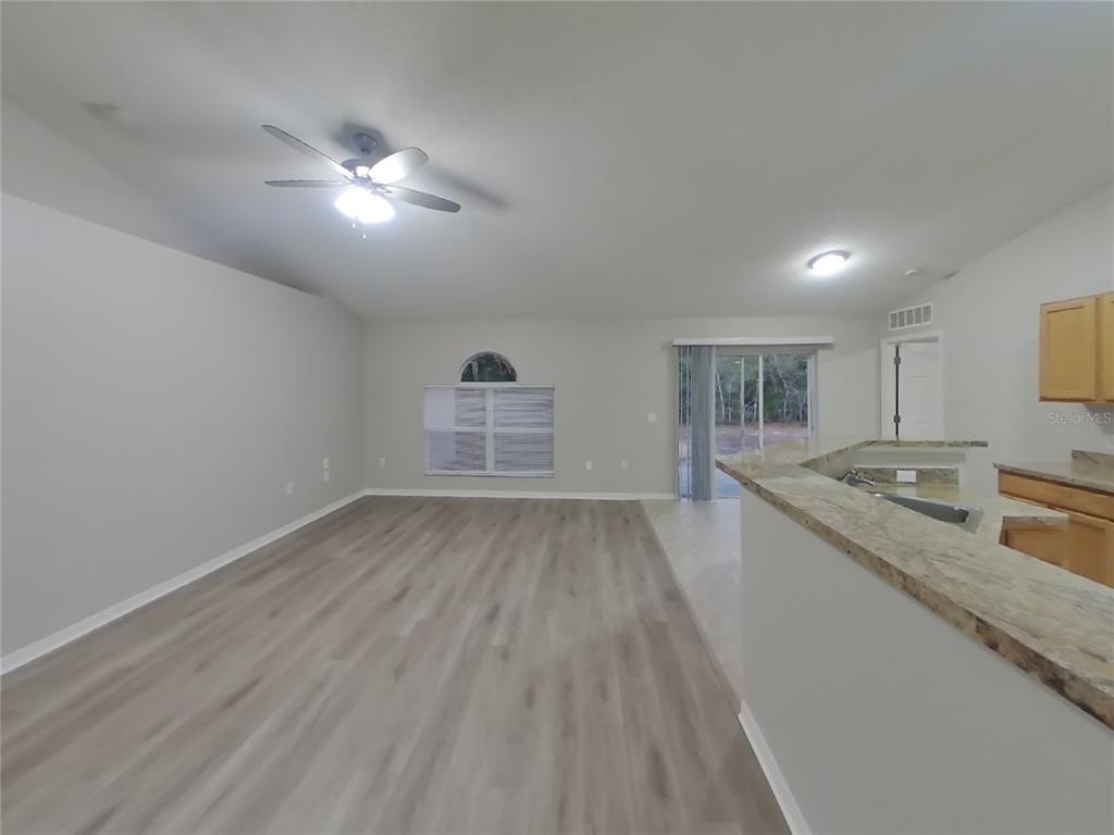Undisclosed Address Spring Hill, FL 34609 - Photo 3 of 17 a view of a kitchen from the hallway