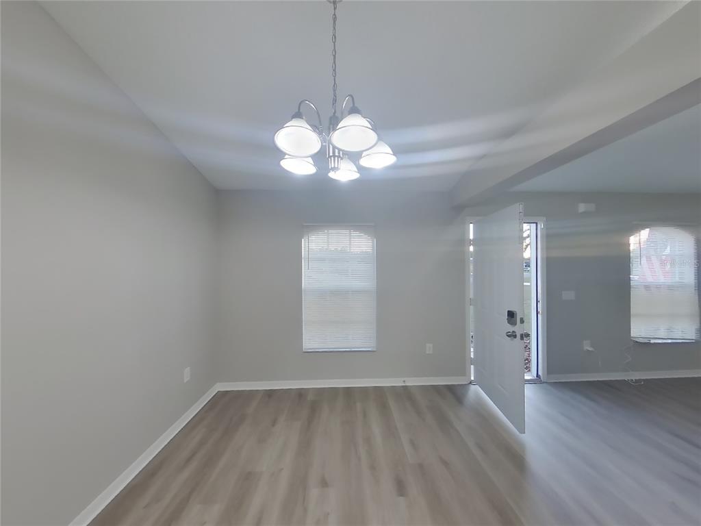 Undisclosed Address Spring Hill, FL 34609 - Photo 4 of 17 a view of a room with wooden floor and a window