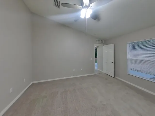 an empty room with a empty space and a ceiling fan