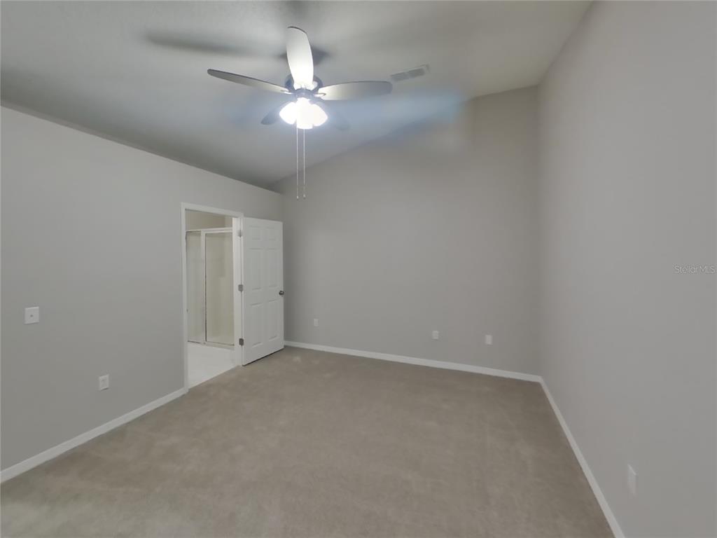 Undisclosed Address Spring Hill, FL 34609 - Photo 8 of 17 a view of an empty room with a chandelier fan