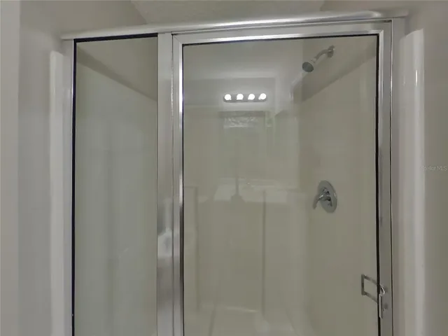 a bathroom with a glass shower door