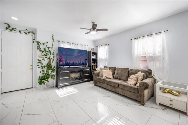 a living room with furniture and a flat screen tv