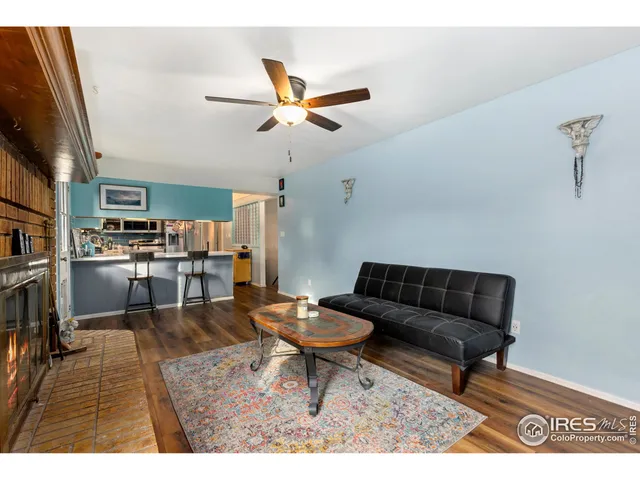 a living room with lots of furniture and kitchen view