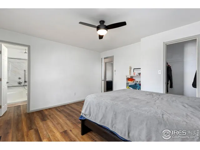 a bed room with a bed and a ceiling fan