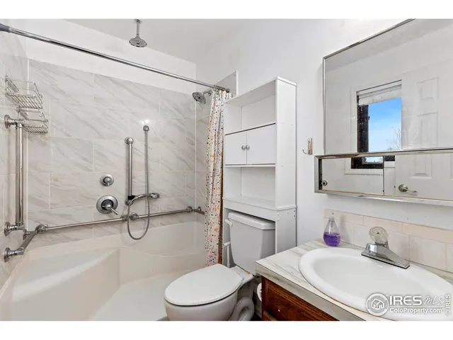 a bathroom with a sink toilet a mirror and shower