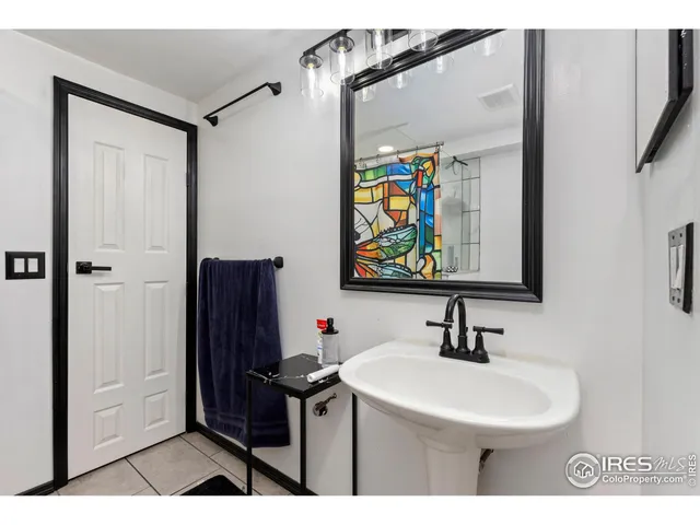 a bathroom with a sink a mirror and a shower